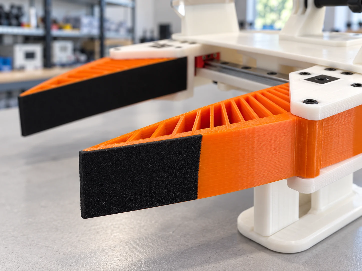 Orange flexible fingers and black contact surfaces